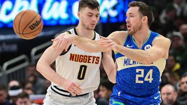 Milwaukee Bucks guard Pat Connaughton (24) passes against Denver Nuggets forward Christian Braun (0) 